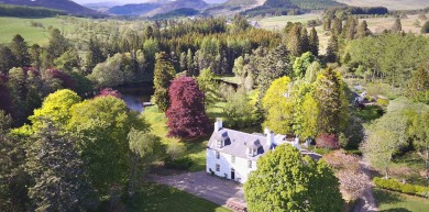 Spring sunshine over Cray House and the foot-hills of Glenshee